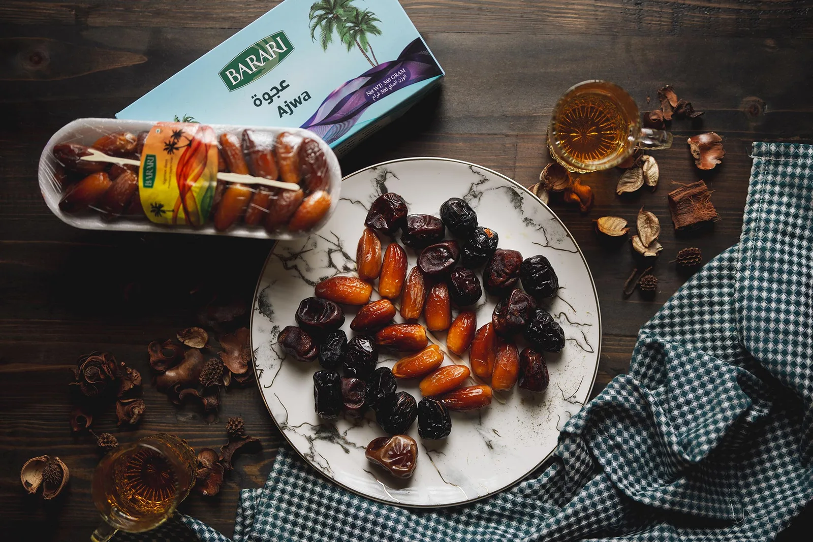 Boxes of Barari Ajwa and premium dates on a marble table